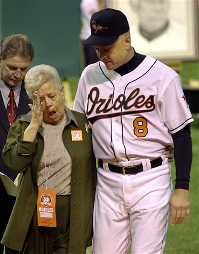 This Oct. 6, 2001 file photo shows Cal Ripken escorting his mother, Vi, from the field, after throwing out the ceremonial first pitch before Cal's final game, at Oriole Park in Baltimore. Police say Cal Ripken Jr.'s mother is safe after an armed man abducted her from her home northeast of Baltimore. Aberdeen police say 74-year-old Vi Ripken was kidnapped between 7 a.m. and 8 a.m. Tuesday, July 24, 2012, by a man who forced her into her car. (AP Photo/Nick Wass)