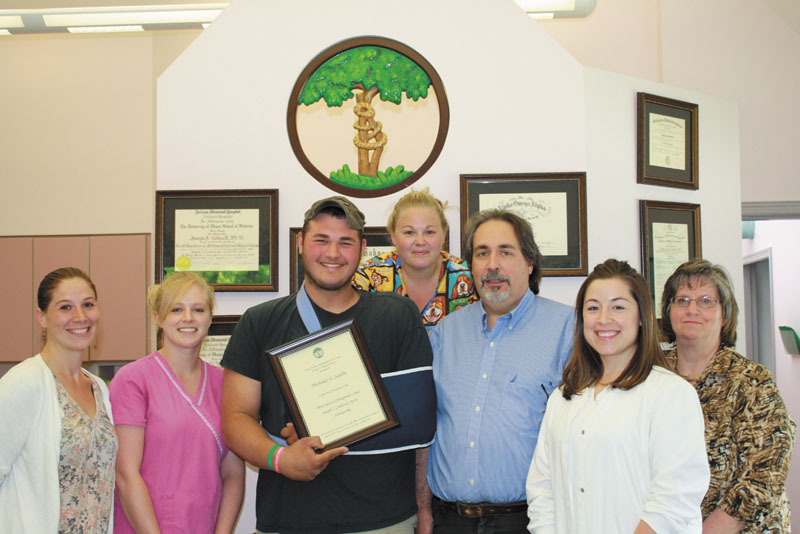 Nicholas Searles, center, scholarship recipient, recently displayed his award with Three Rivers Orthopedics staff after he visited to express his appreciation. From left are Julia Hartigan, Heather Dawes, Searles, Kristin Scott, Dr. Joseph Caldwell, Kristina Turner and Rachel Heath.