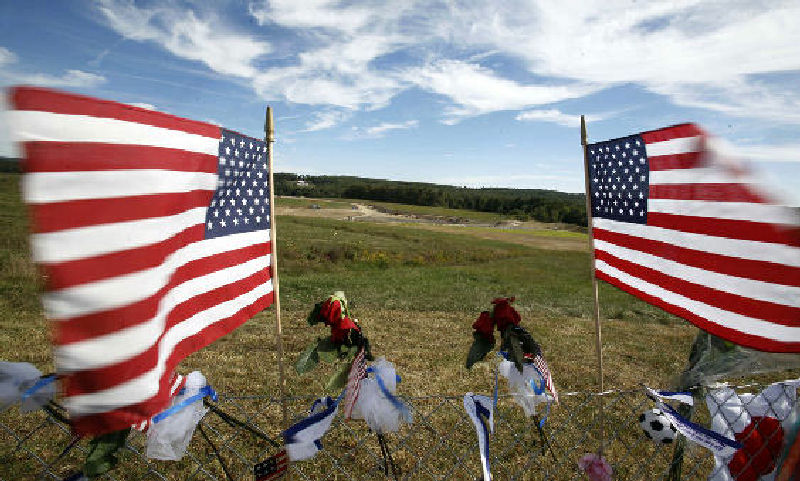 Flags frame the crash site of United Flight 93 on Sept. 11, 2010, at the temporary Flight 93 memorial in Shanksville.