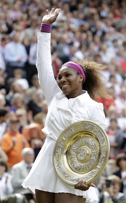 Serena Williams of the United States celebrates with the trophy after defeating Agnieszka Radwanska of Poland to win the women's final match at the All England Lawn Tennis Championships at Wimbledon, England, Saturday, July 7, 2012. (AP Photo/Kirsty Wigglesworth)