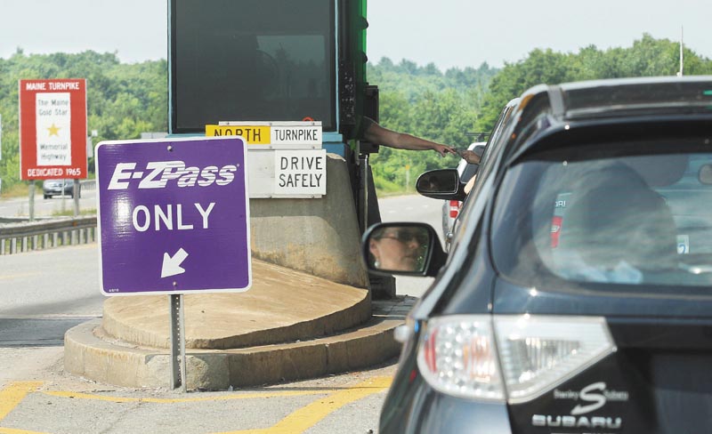 PAYING THE TOLL: Motorists in the northbound lane of I-295 enter the Gardiner toll station on Monday.