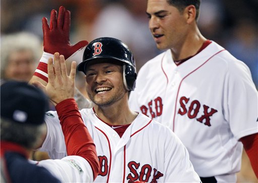 Boston Red Sox's Cody Ross, center, celebrates his three-run home run that also drove in Jacoby Ellsbury, right, in the third inning of a baseball game against the Chicago White Sox in Boston, Wednesday, July 18, 2012. (AP Photo/Michael Dwyer)