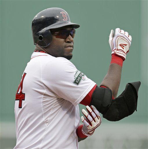 Boston Red Sox designated hitter David Ortiz takes off his elbow protector after his at-bat in the first inning of the first baseball game against the New York Yankees in a day-night doubleheader at Fenway Park in Boston Saturday, July 7, 2012. (AP Photo/Elise Amendola)