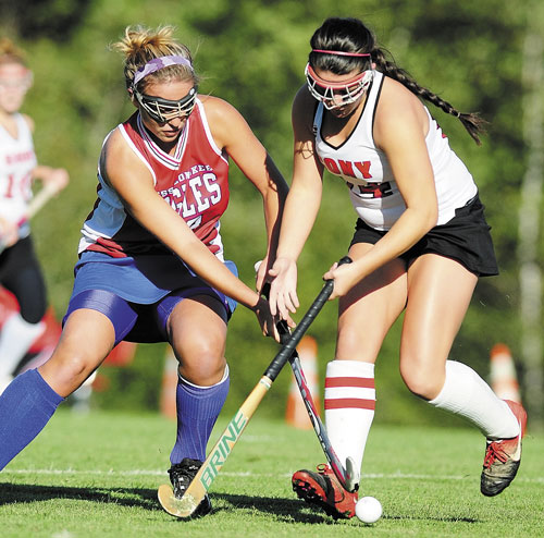 JOINING FORCES: Messalonskee’s Katie Bernatchez, left, tries to get past Cony’s Chelsea Begin during a game last season. Both will play in the McNally Senior All-Star Field Hockey Game on Saturday.