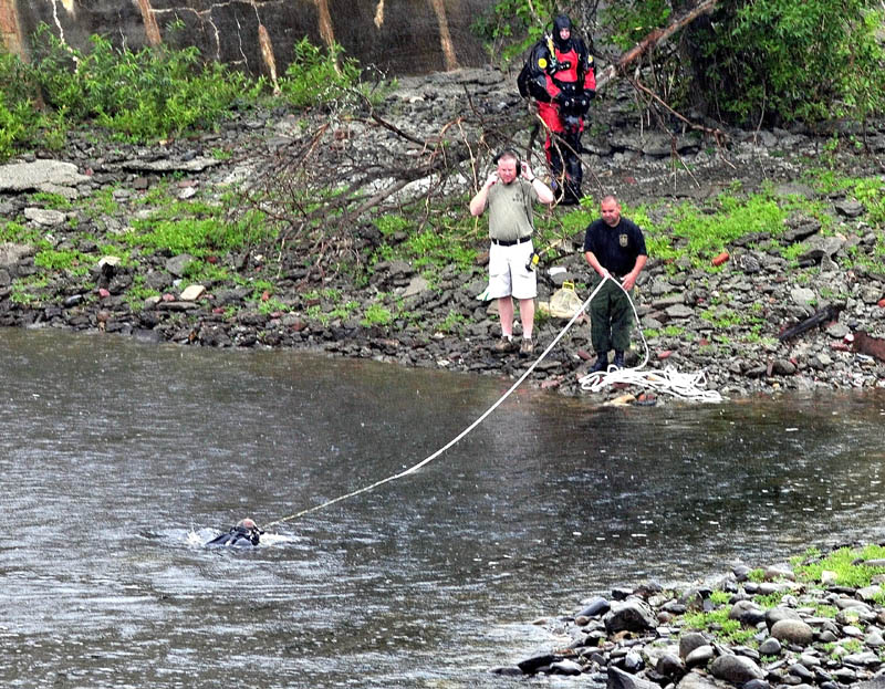 Divers with the Maine State Police and Warden Service enter the Kennebec River below the Lockwood Dam in Waterville on Tuesday to search for missing toddler Ayla Reynolds.