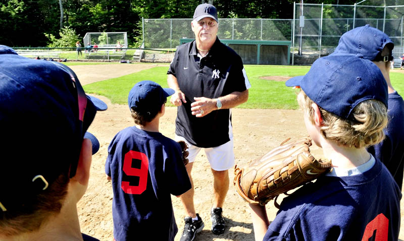 LISTEN TO THIS: Former New York Yankees player Bucky Dent gives pointers to kids during a baseball camp Monday at Little Fenway Park in Oakland.