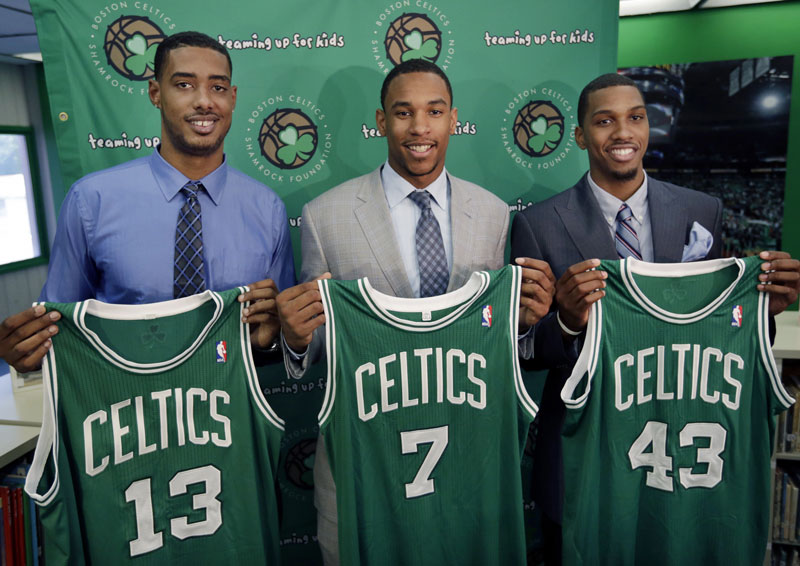 Boston Celtics 2012 draft picks, from left, center Fab Melo and forwards Jared Sullinger and Kris Joseph hold up their jerseys during a news conference Monday in Boston.