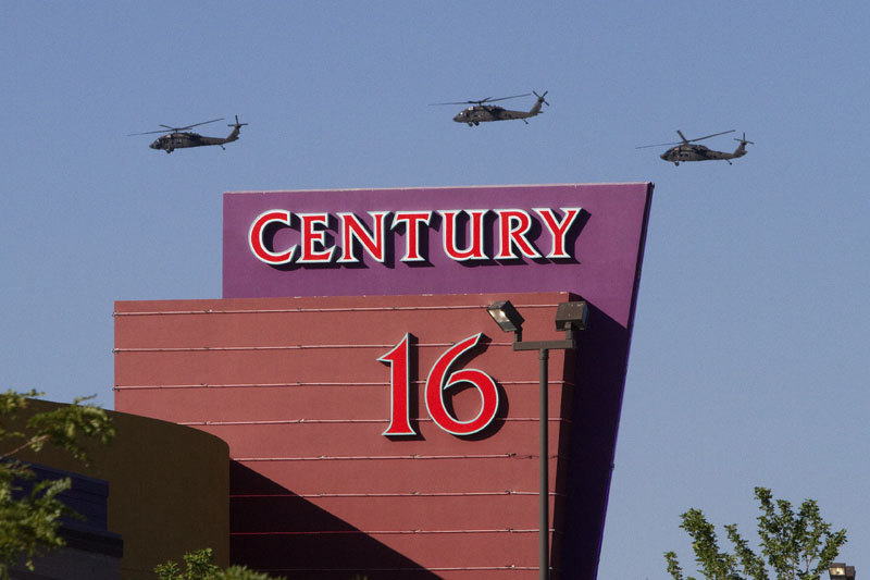 Three helicopters fly over the Century Theater on Saturday in Aurora, Colo.