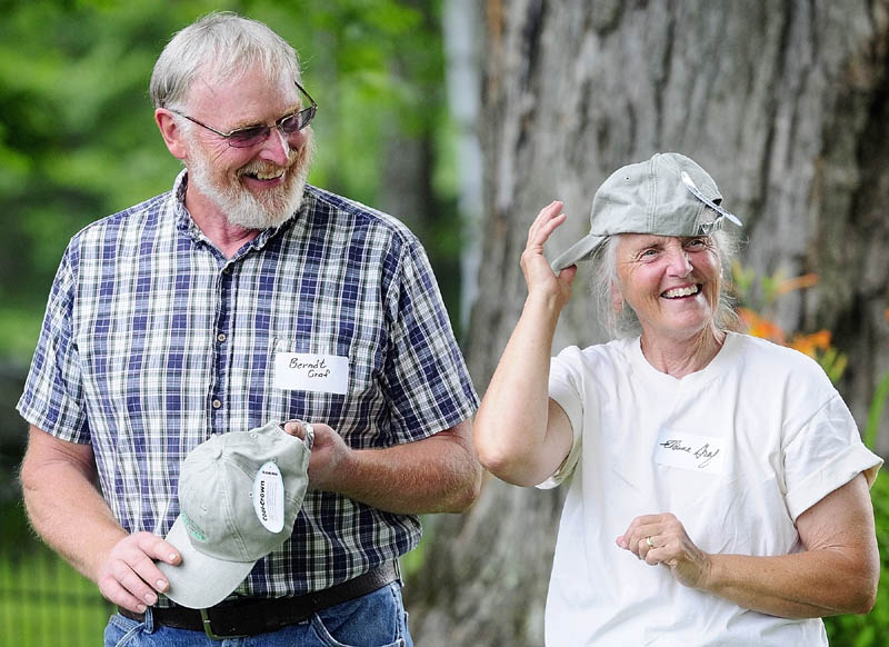 Dairy farmers Berndt and Elaine Graf joke around with the Kennebec Land Trust hats they were given during a ceremony on Saturday morning at the Fayette Corner Baptist Church.
