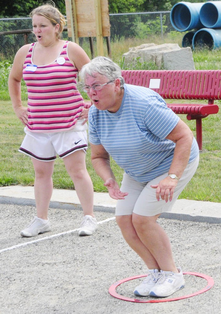 Erica Golden, left, and Cecile Gregoire react to Gregoire's shot during the petanque tournament held in Mill Park as part of the Festival de la Bastille on Saturday afternoon in Augusta.