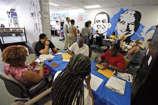 In this photo taken June 28, 2012, President Barack Obama 2012 volunteers have a meeting at campaign headquarters in Richmond, Va. Call them passionate, idealistic, earnest, even a tad naive: The volunteers helping to power the Obama and Romney campaigns are outliers at a time when polls show record low public satisfaction with government and a growing belief that Washington isn�t on their side. While motivated by opposing goals, the Obama and Romney volunteers share at least one key trait: an abiding faith in the political process and a belief that it still matters who occupies the White House. (AP Photo/Steve Helber)