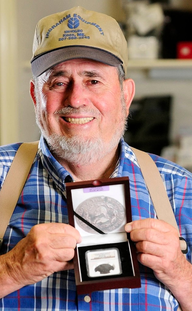 Thomas Donlon holds up a case holding the 1800 George Washington funeral medallion that he bought on eBay and recently had authenticated.