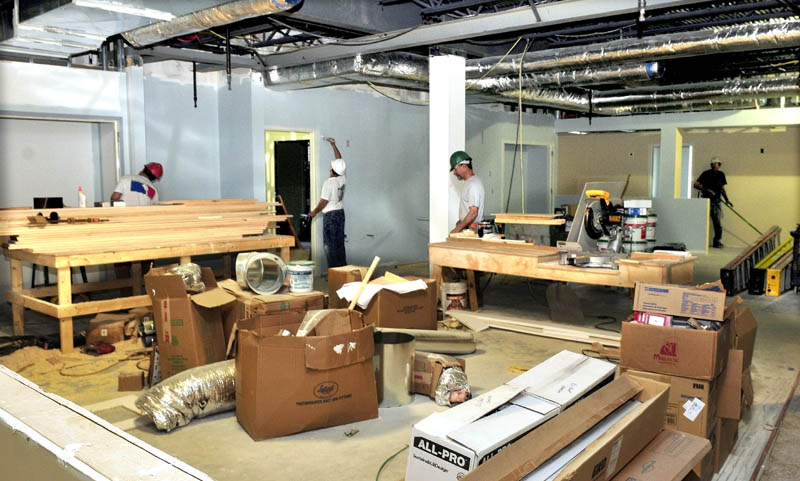 Workers are shown in the large kitchen area at the new Mid-Maine Homeless Shelter in Waterville last week.