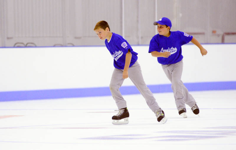 Owen Cox, left, and Ryan Pomerleau try out the new ice in The Bank of Maine Ice Vault on Saturday in Hallowell. They had on baseball cleats while taking the tour and co-owner Peter Prescott suggested that the borrow some rental skates and try it out, so they did.