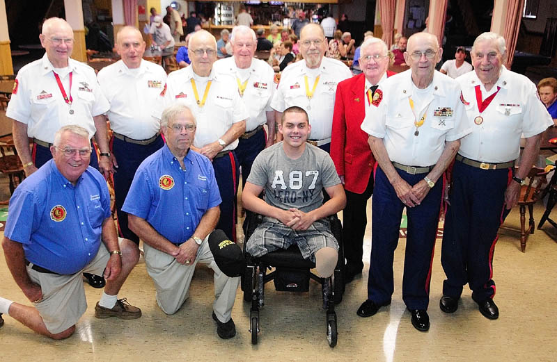 Jeremy Gilley, center, poses for a group shot with members of Le Club Calumet and Marine Corps League Detachment # 599 at a fundraiser held on Wednesday night at Le Club Calumet in Augusta. Gilley received donations from the Marine Corps League and the Club.