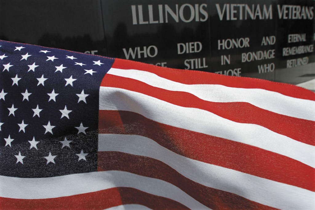 A United States flag blows in the wind near the Illinois Vietnam Memorial on Tuesday in Springfield, Ill. Today is a day when some ponder on what the Fourth of July means.