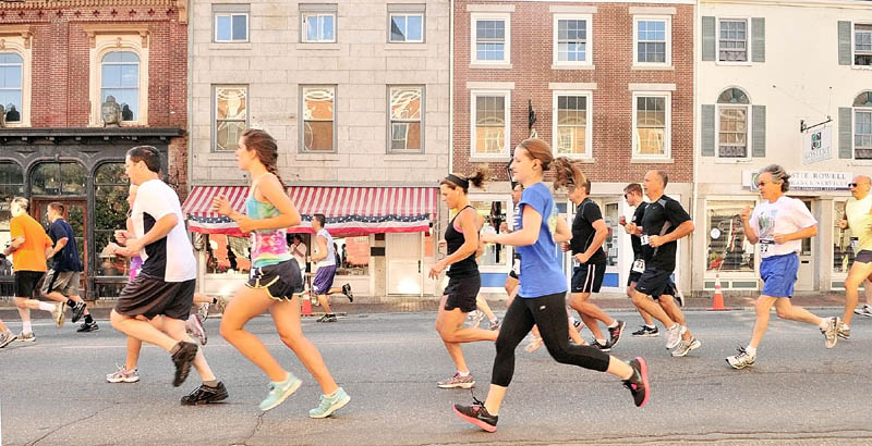 Runners head north on Water Street at the start of the Old Hallowell Day 5k race on Saturday in Hallowell. Later in the morning, there was a larger crowd of spectators as a parade went in the opposite direction.