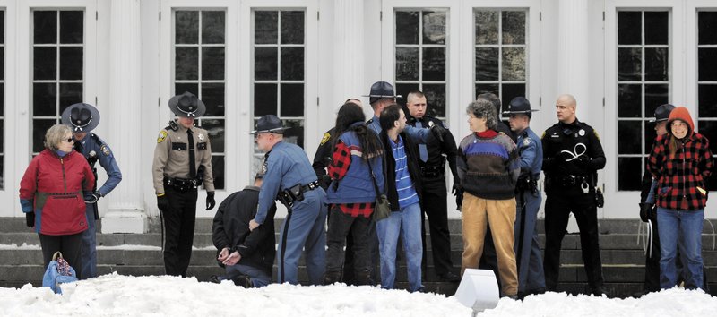 Andy Molloy/Kennebec Journal Protesters are arrested Sunday on the lawn of the Blaine House during a rally by Occupy Augusta. Police said nine people were charged with criminal trespass and failure to disperse after refusing to leave the lawn of the governors mansion.