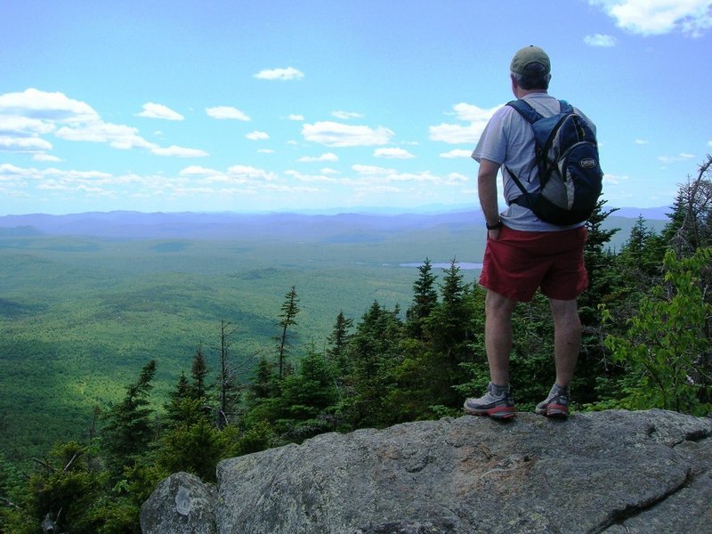 Carey Kish of Bowdoin looks out from the summit of Mt. Blue, where the views include Saddleback, Abraham, Spaulding and Sugarloaf mountains, as well as the Presidential, Carter and Mahoosuc ranges.