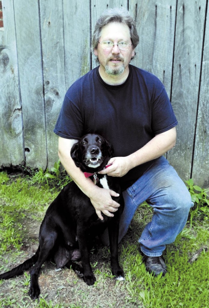 Mike Topich and his dog, Molly Belle, sit during a quiet moment in Thorndike on Sunday. Tragedy stuck recently when a rabid skunk attacked 11 puppies before Topich intervened. The puppies were euthanized and Topich was treated for rabies exposure.