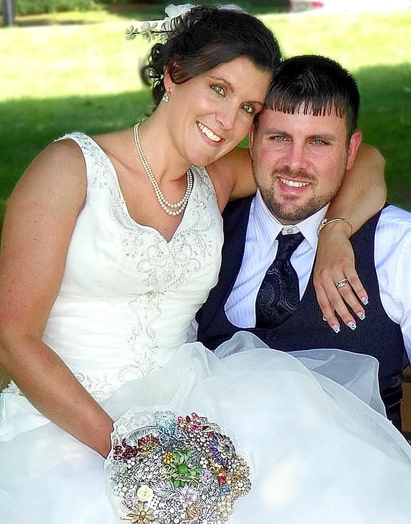 LOST TREASURE: Sara and Josh Norton were married June 30 at the park beside the Winslow Town Office. Here, Sara Norton is holding a bouquet made of family brooches that went missing after the wedding.