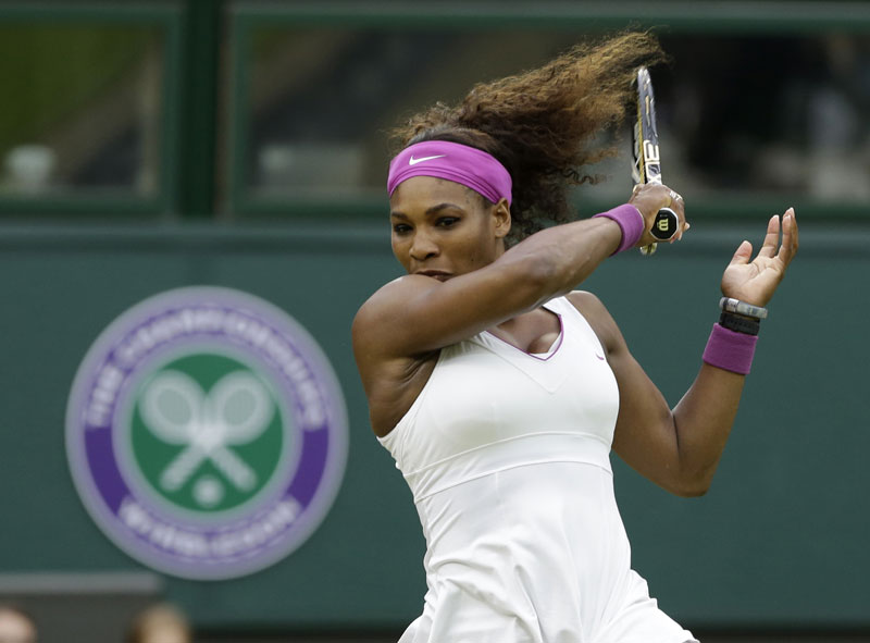 MOVING ON: Serena Williams hits a forehand to Petra Kvitova during their quarterfinals match Tuesday at the All England Lawn Tennis Championships at Wimbledon, England. Williams beat the defending champ 6-3, 7-5.