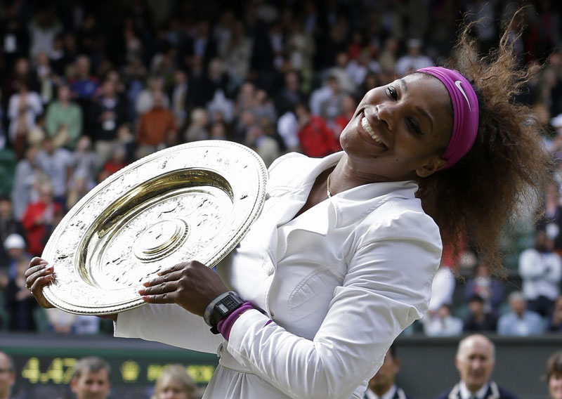 ALL SMILES: Serena Williams poses with her trophy after defeating Agnieszka Radwanska 6-1, 5-7, 6-2 to win her fifth Wimbledon title, on Sunday at the All England Lawn Tennis Championships at Wimbledon, England.
