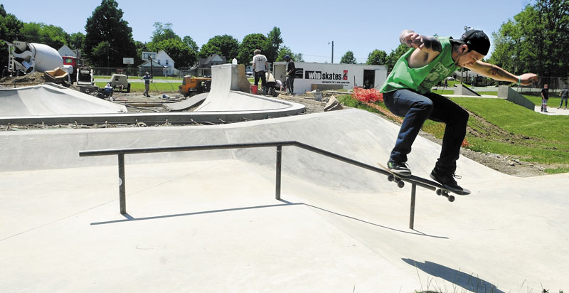 A PLACE TO SKATE: Nolan Brann of Augusta skateboards at the Augusta Skate Park as the Who Skates crew continues building the phase two bowl section in the background in June. Work on the park has been completed and a number of skaters took advantage on the park Monday.