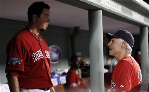 Boston Red Sox manager Bobby Valentine, right, talks with starting pitcher Josh Beckett in the dugout during the sixth inning of Friday'sl game against the Toronto Blue Jays at Fenway Park in Boston.