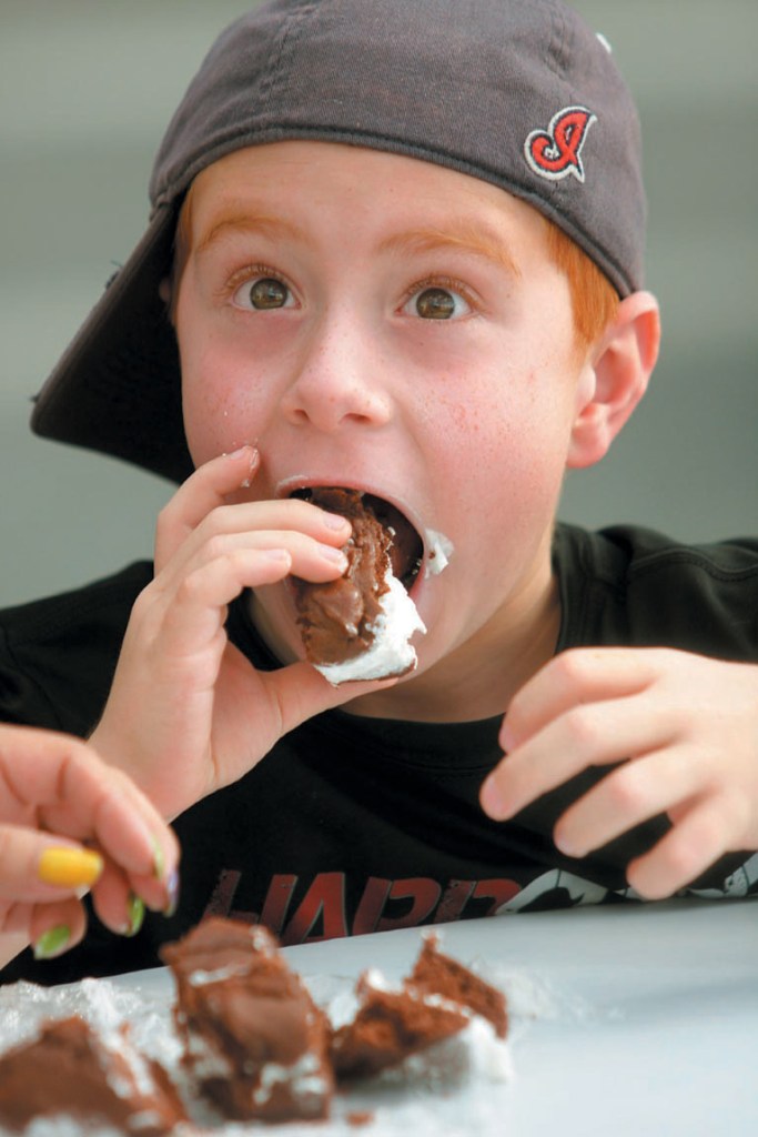 Noah Mitchell, 8, of Solon, Ohio takes a bite of a whoopie pie from T&B's Outback Tavern during last summer's Taste of Greater Waterville festival.