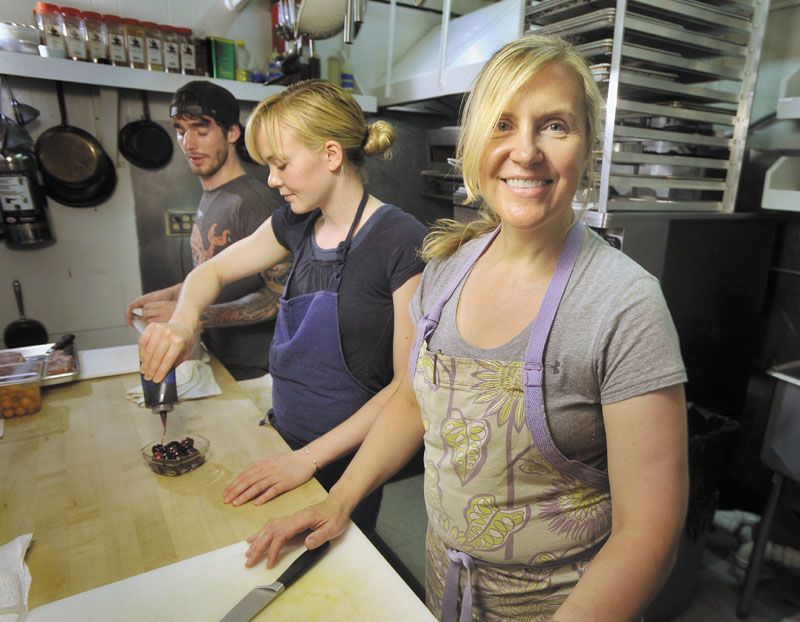 Women earn 22 percent less than men in Maine for full-time work, and the gap exists in virtually every occupation, according to the latest workforce data. It's true in the food preparation and service industry, and Krista Kern Desjarlais, foreground, doesn't need numbers to prove it. In 30 years in the business, she has seen the disparity in pay first hand and she she is careful to pay her help — men and women — the same wage. Her helpers Blaine Pitcock, left, and Shelby Stevens work in the kitchen of her restaurant, Bresca, on Middle Street in Portland.