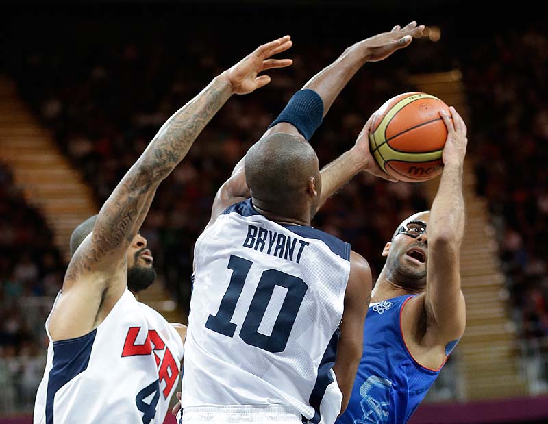Tony Parker of France looks to shoot against USA's Tyson Chandler, left, and Kobe Bryant during the first half Sunday at the 2012 Summer Olympics. The US won, 98-71.