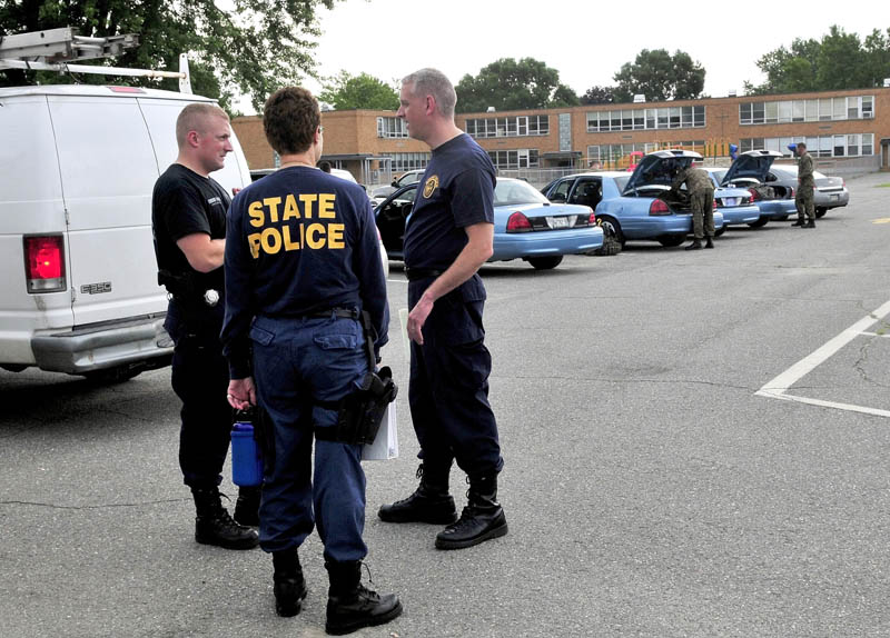 STAND DOWN: Maine State Police tactical team members disband in Winslow on Wednesday morning after Matt Savinelli was taken into custody following a standoff that began Tuesday evening.