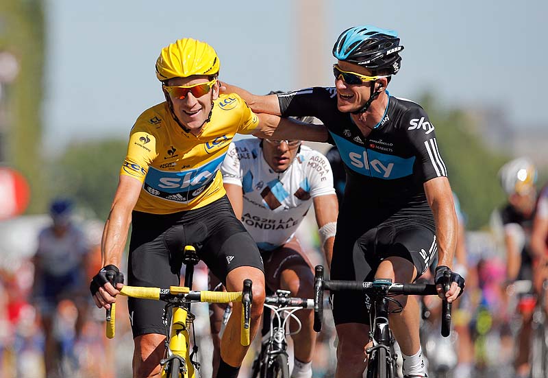Bradley Wiggins, winner of the 2012 Tour de France, is congratulated by Michael Rogers of Australia after crossing the line of the 20th stage of the race today in Paris. He is the first Briton to win the race,