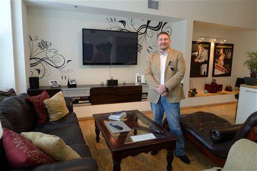 In this photo taken Aug. 10, 2012, James Griffin of Tampa stands in the living room of his condo in the city's downtown. Griffin is asking $1,250 a night to rent his home for the Republican National Convention. The only offers he's had so far are from protesters wanting to spend $100 a night. (AP Photo/Tamara Lush)