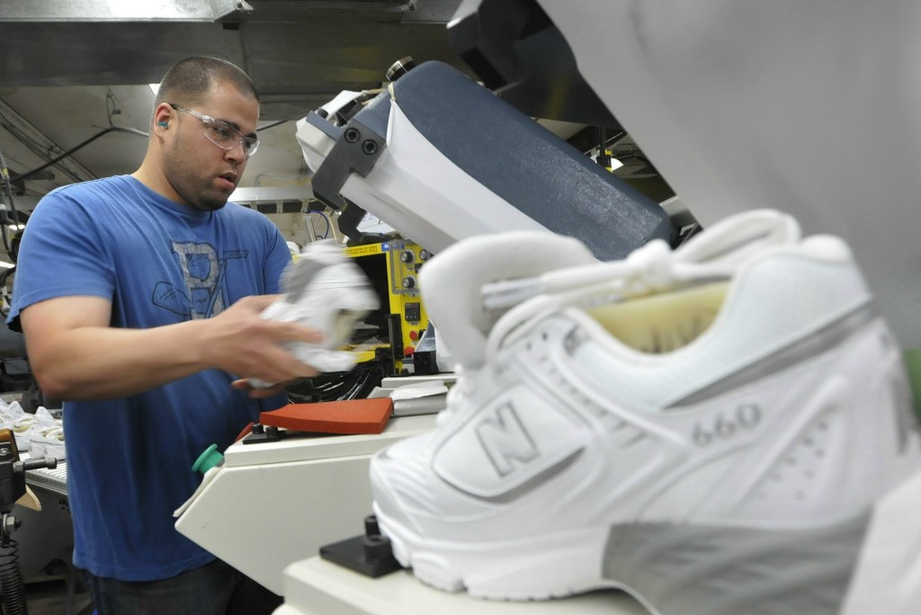 Staff Photo by Shawn Patrick Ouellette: Justin Waring lays souls on shoes at New Balance in Norridgewock Monday, May 9, 2011.