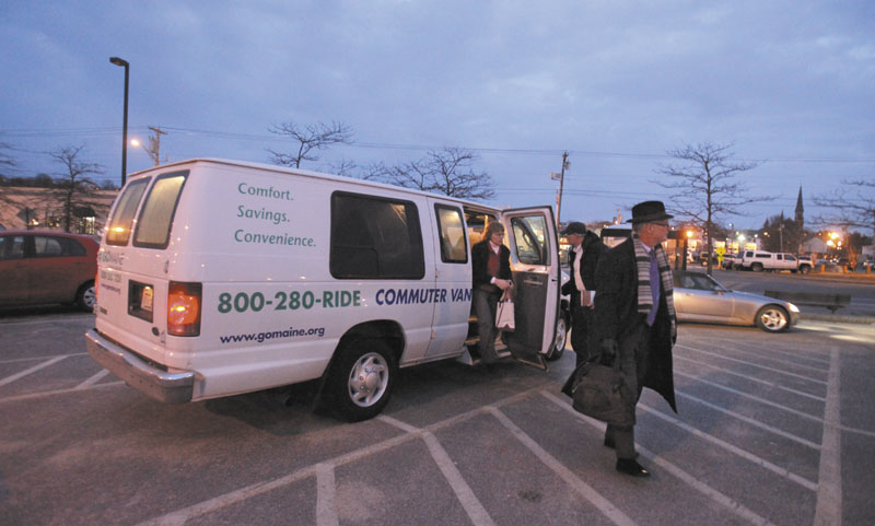 Commuters exit a van at the park and ride lot on Marginal Way in Portland last February. The state has been providing a van pool service since 2002 but is suspending the service and plans to turn it over to a private company in May.