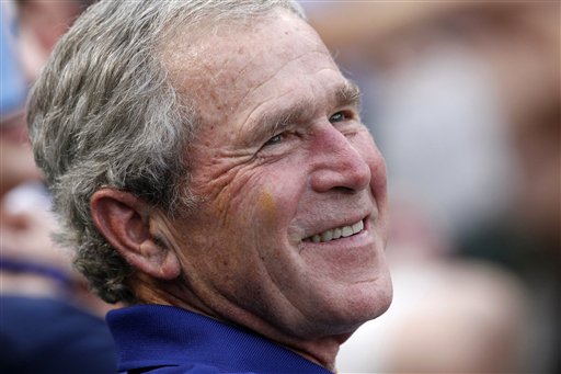 FILE - In this June 16, 2012 file photo, former President George W. Bush smiles as he takes in a baseball game in Arlington, Texas. The Rangers won 8-3. Sarah Palin and George W. Bush won�t be in Tampa. Hillary Rodham Clinton and Al Gore aren�t making the trip to Charlotte. And scores of other Republican and Democratic stars are taking a pass as their parties gather at every-four-years national conventions. The reasons are varied _ and political. (AP Photo/LM Otero, File)