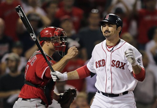 Boston Red Sox's Adrian Gonzalez, right, reacts as he strikes out swinging to end the game as Los Angeles Angels catcher Chris Iannetta pumps his fist in the bottom of the 10th inning of a baseball game at Fenway Park in Boston, Thursday, Aug. 23, 2012. The Angels defeated the Red Sox 14-13. (AP Photo/Charles Krupa)