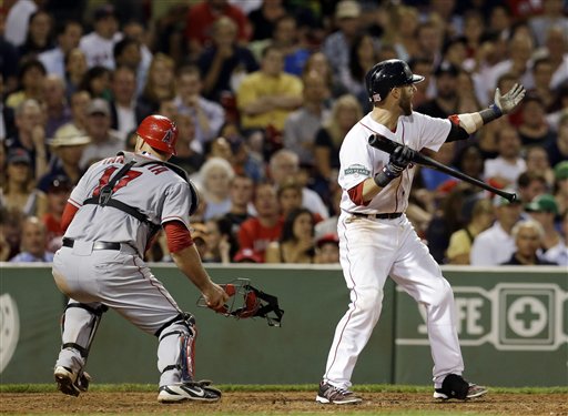 Boston Red Sox's Dustin Pedroia waves in Scott Podsednik to score from third as Los Angeles Angels catcher Chris Iannetta (17) chases down a wild pitch during the seventh inning of a baseball game in Boston Tuesday, Aug. 21, 2012. (AP Photo/Elise Amendola)