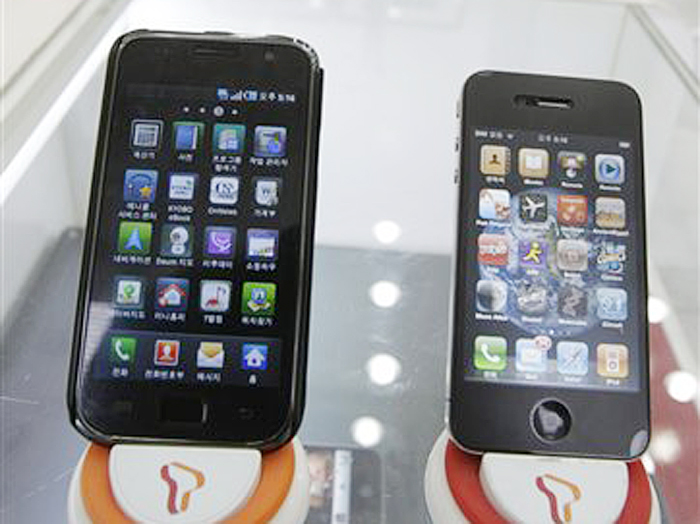 Samsung Electronics' Galaxy S, left, and Apple's iPhone 4 are displayed at a mobile phone shop in Seoul, South Korea. Apple Inc. filed a lawsuit against Samsung Electronics Co. last year alleging the world's largest technology company's smart phones and computer tablets are illegal knockoffs. Samsung countered that it's Apple that is doing the stealing and, besides, some of the technology at issue such as the rounded rectangular designs of smart phones have been industry standards for years.