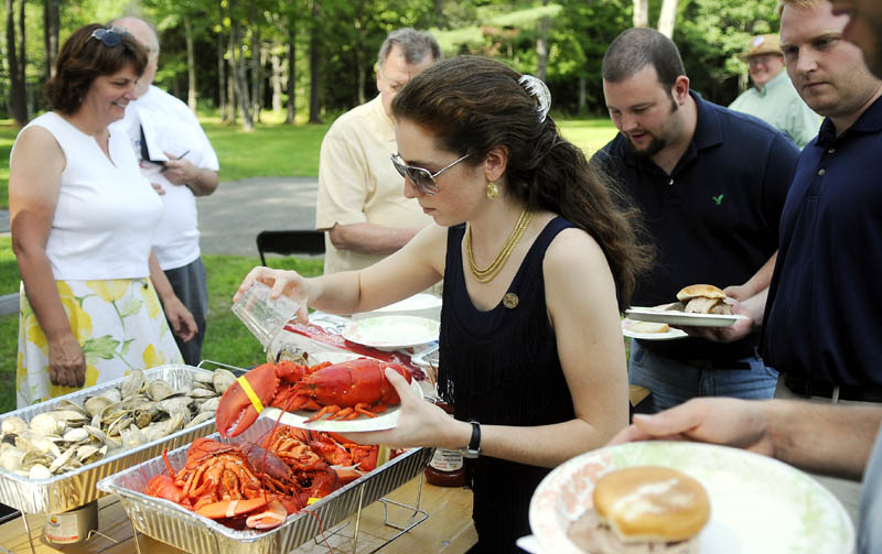 Ashley Ryan, of South Portland, the National Committeewoman Elect for the Maine Republican Party, scoops up clams Sunday during the Maine Liberty Caucus' 3rd annual Calvin Coolidge Clambake in Sidney.