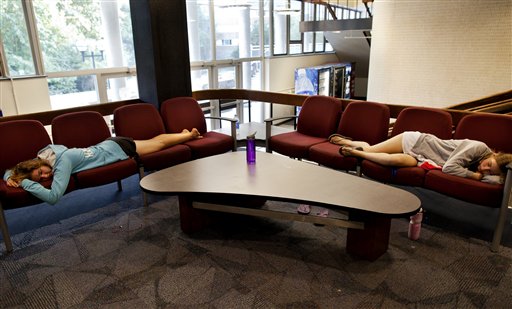 Engineering students Noelle Hansford, left, and Andrea Case take a nap in the lobby of Bursley Hall on the campus of the University of Michigan, in Ann Arbor, Mich. recently.