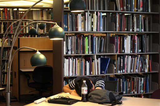 Taewon Kim, an electrical engineering systems graduate student, naps in the library on the campus of the University of Michigan, in Ann Arbor, Mich.