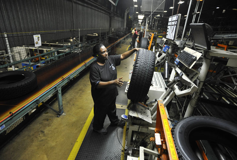 Tire inspector Flora Roundtree checks a tire for defects July 24, at a Michelin manufacturing plant in Greenville, S.C., which produces about 25,000 tires a day. The U.S. economy generated 163,000 jobs in July after three months of weak hiring.