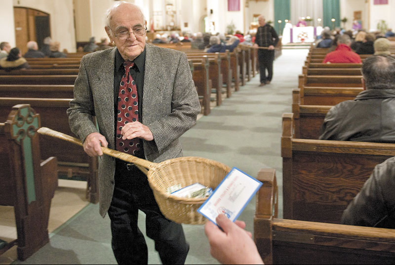 John Alves, of Dartmouth, Mass., uses a basket while taking collection during Mass on Dec. 19, 2009, at St. John the Baptist Roman Catholic Church in New Bedford, Mass. A study on the generosity of Americans, released Monday by the Chronicle of Philanthropy, found that states with populations that are less religious are also the stingiest about giving money to charity.