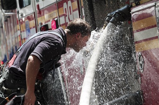 A New York City firefighter cools off in this July 17, 2012, photo.