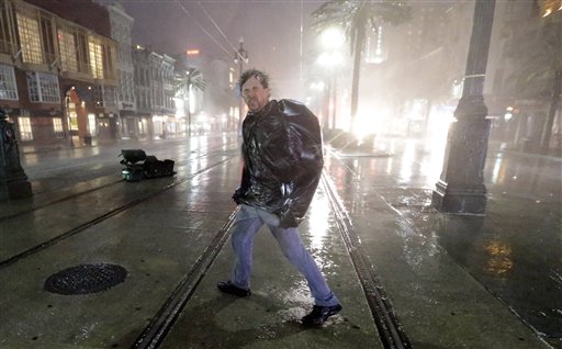 A man crosses Canal Street in the wind and rain from Hurricane Isaac Wednesday, Aug. 29, 2012, in New Orleans. (AP Photo/David J. Phillip)
