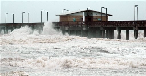 Waves crash into the public fishing pier at Gulf State Park in Gulf Shores, Ala., shortly before Hurricane Isaac made landfall in Louisiana on Tuesday. Crews removed flooring panels from the pier to prevent damage.