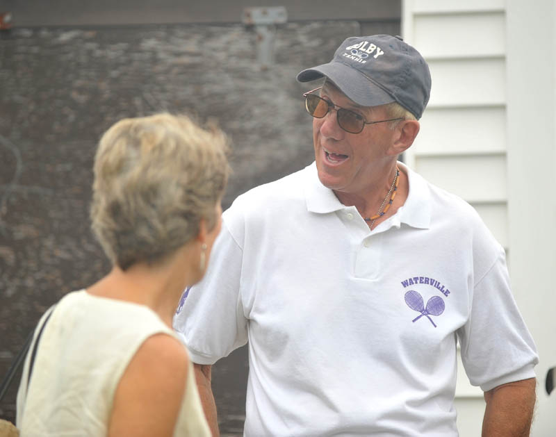 Waterville Senior High School tennis coach Jim Begin talks to Sue Cook of Waterville before the North Street tennis court were renamed the Jim Begin Recreational Tennis Courts on Friday.